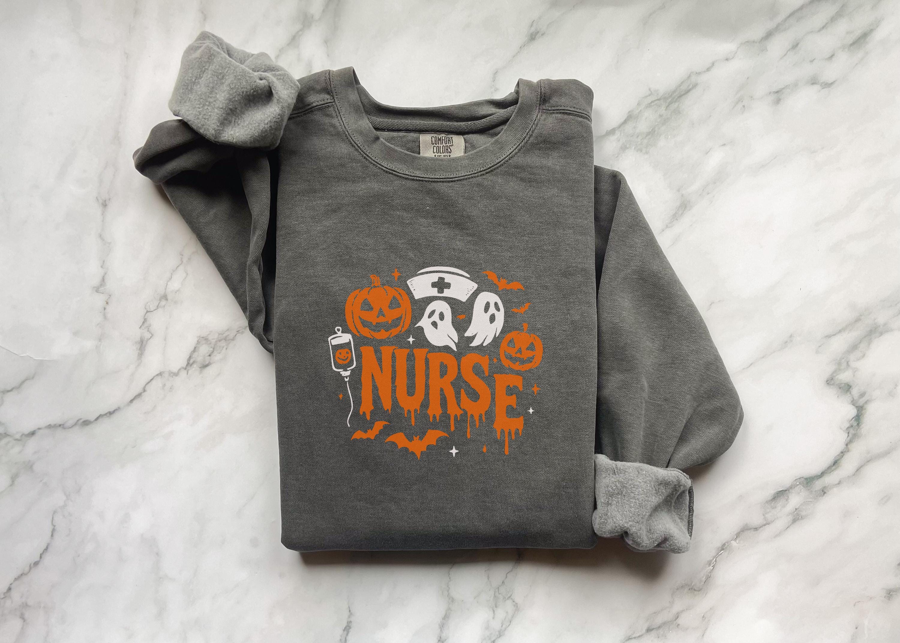 Halloween Nurse Sweatshirt – Spooky Season Shirt with Ghosts, Pumpkins & Nurse Hat, Gift for nurse RN Healthcare workers