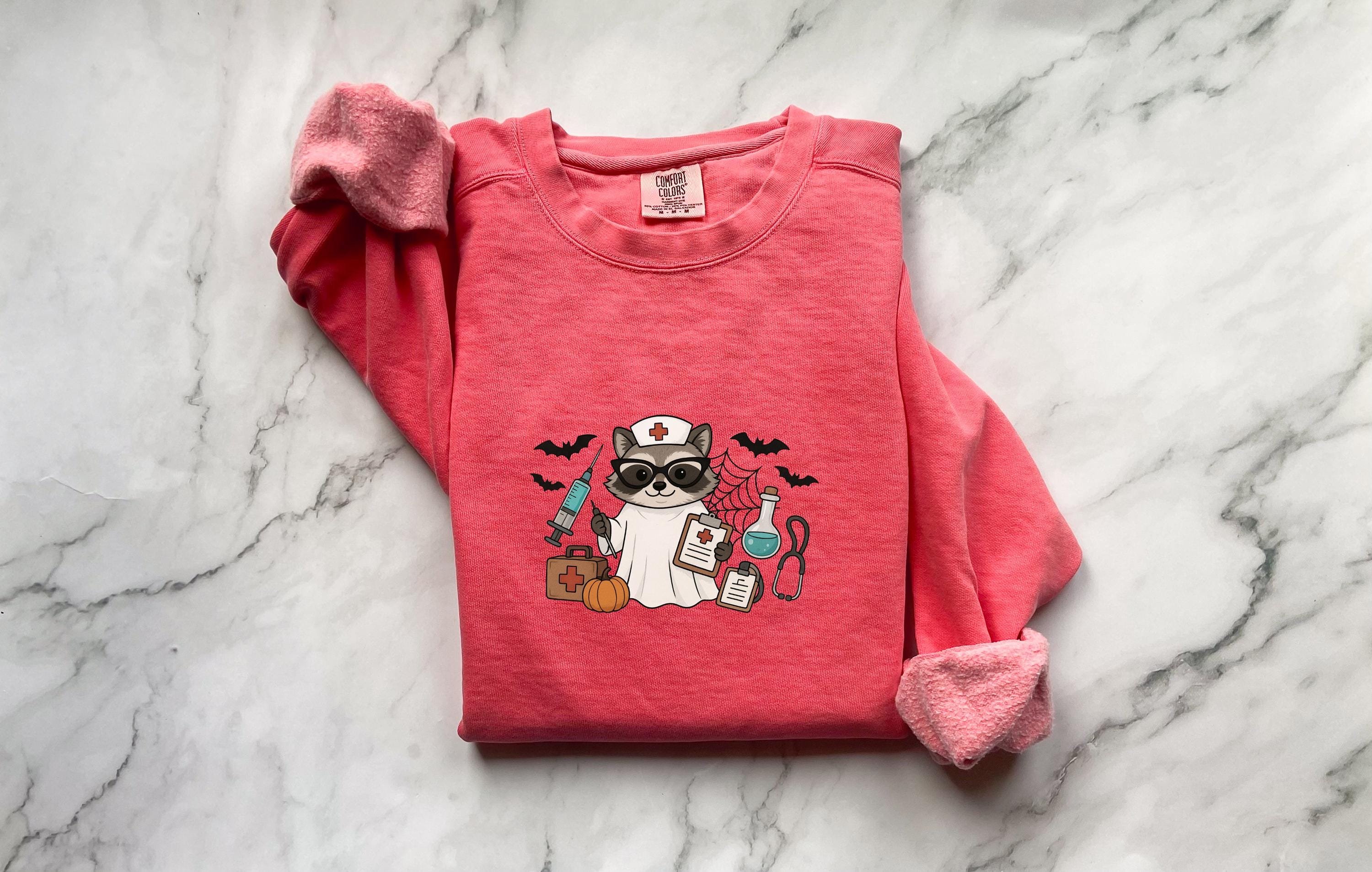 Raccoon Nurse Halloween Sweatshirt, Spooky RN Fall Top, Funny Cozy Autumn Pullover, Cute Retro Gift for Nurse