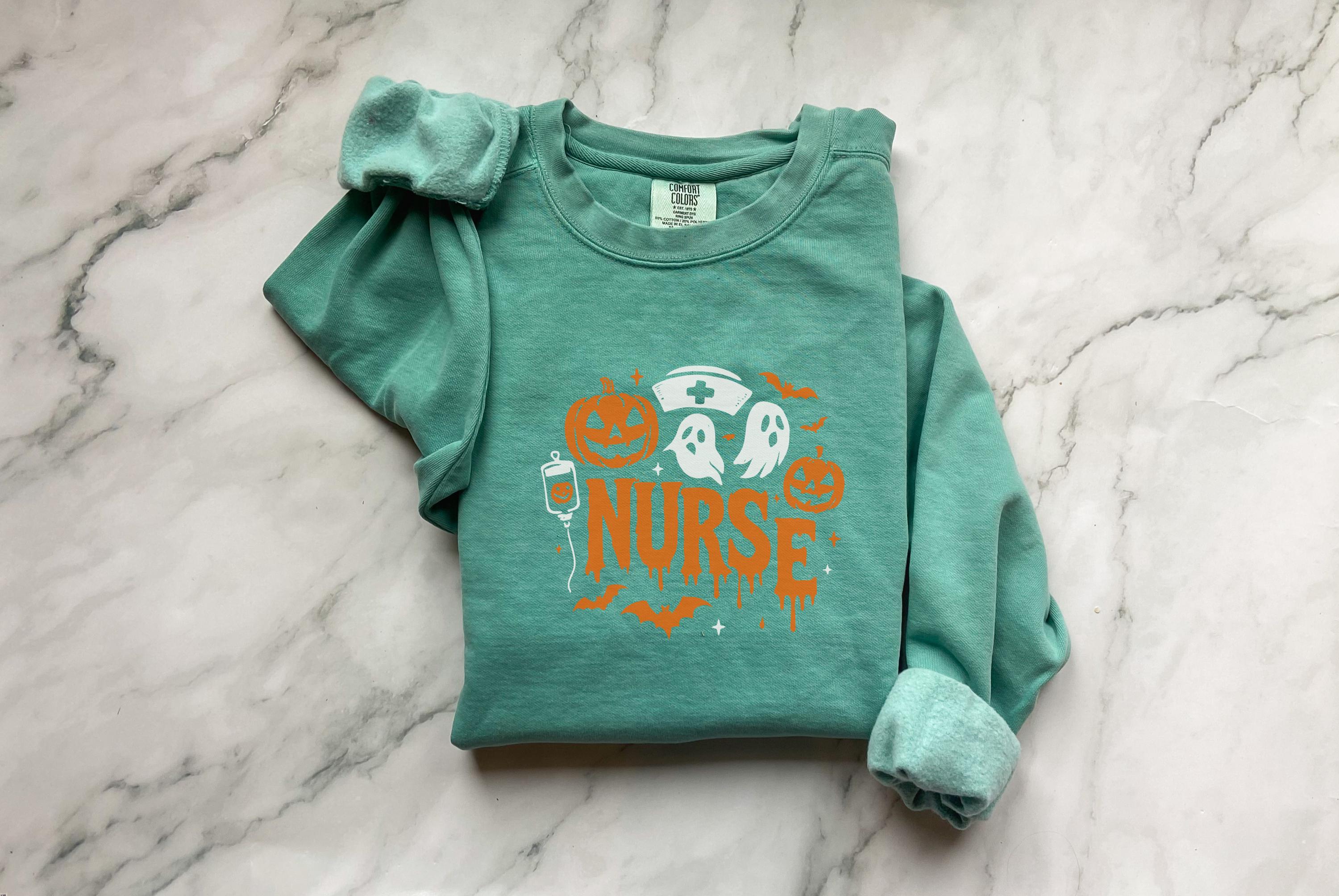 Halloween Nurse Sweatshirt – Spooky Season Shirt with Ghosts, Pumpkins & Nurse Hat, Gift for nurse RN Healthcare workers