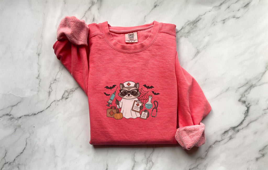 Raccoon Nurse Halloween Sweatshirt, Funny Halloween Nurse Shirt, Spooky Gift for Nurse RN, Fall Nurse Shirt, Unisex Medical Tee