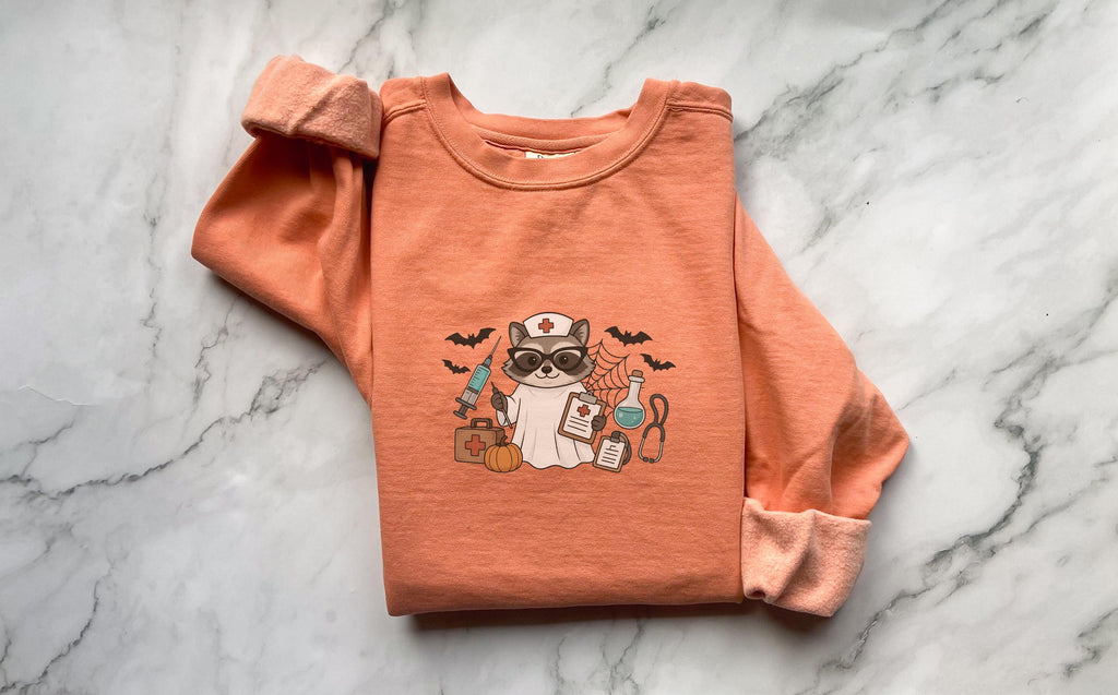 Raccoon Nurse Halloween Sweatshirt, Spooky RN Fall Top, Funny Cozy Autumn Pullover, Cute Retro Gift for Nurse