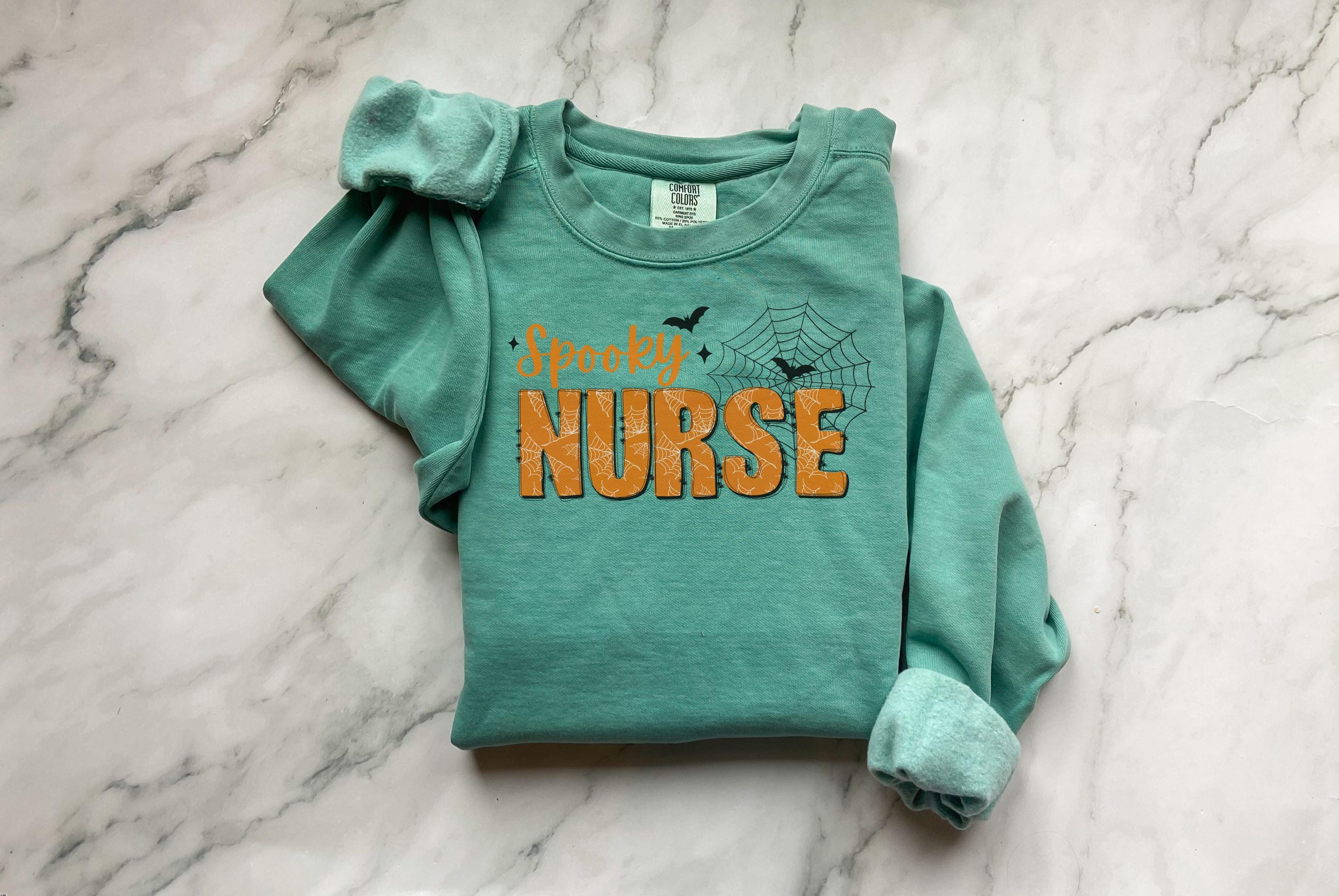 Spooky Nurse Halloween Sweatshirt, Minimalist RN Top with Bats, Cute Fall Medical Apparel, Funny Cozy Autumn Outfit, Unique Gift for Nurse